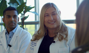 Dr. Crystal Fancher and Dr. Ramkishen Narayanan speak with cancer survivor, Cristine at Saint John's